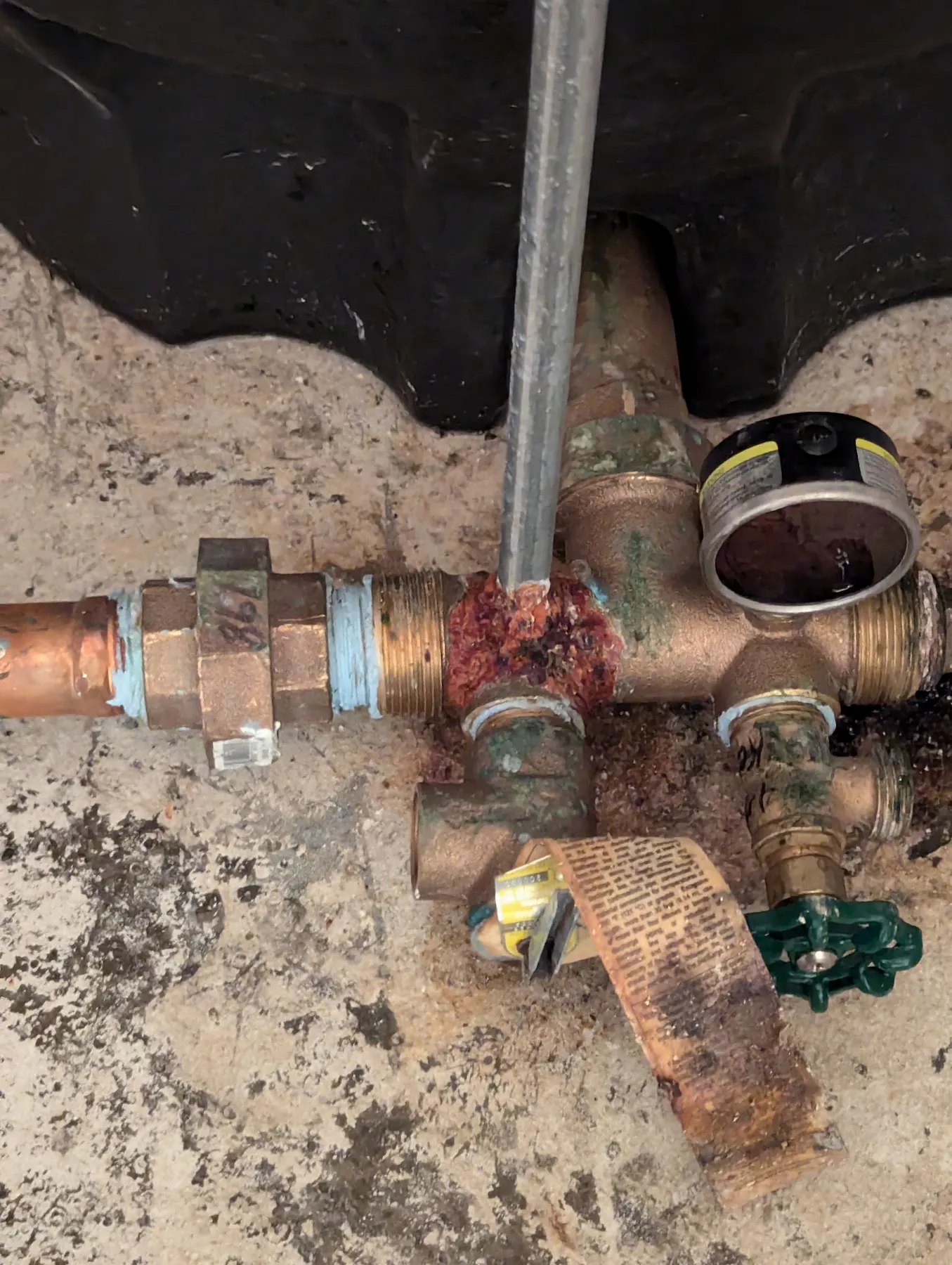 Brass plumbing fittings badly corroded, with green and white buildup on the joints